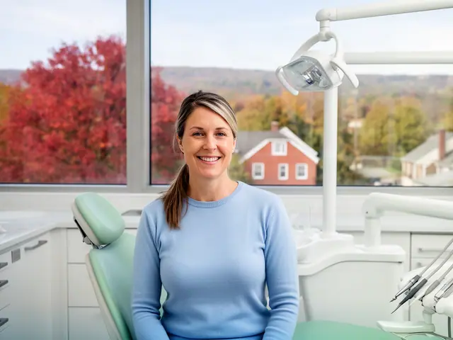 A dentist standing beside a dental chair.